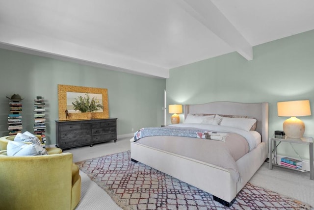 carpeted bedroom with beam ceiling