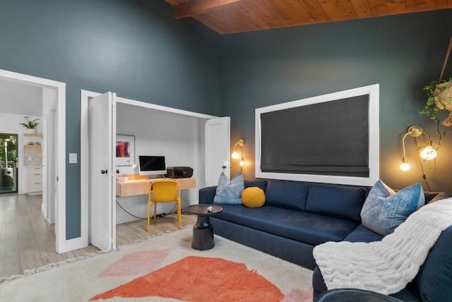 living room with lofted ceiling with beams, wooden ceiling, and light wood-type flooring