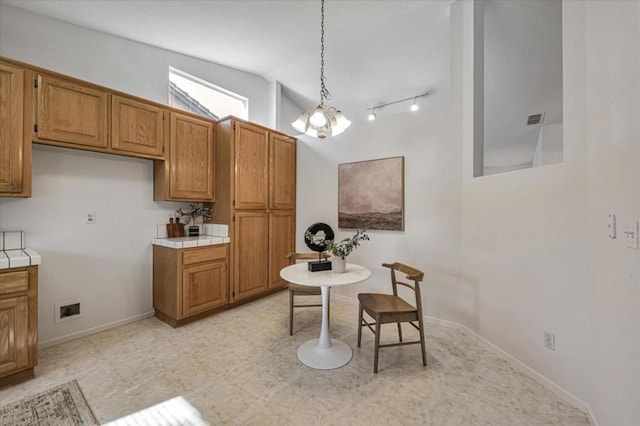 kitchen with lofted ceiling and hanging light fixtures