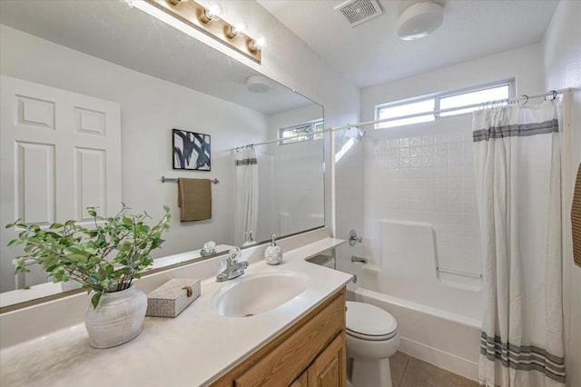 full bathroom with vanity, toilet, tile patterned floors, and shower / bath combo with shower curtain