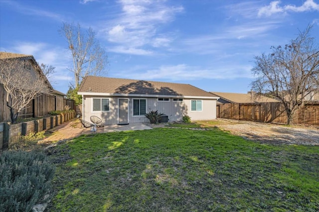 rear view of house with a patio, central air condition unit, and a lawn