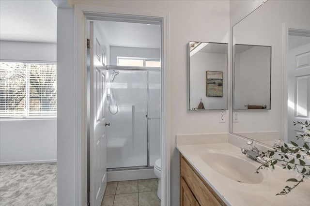 bathroom with tile patterned flooring, vanity, an enclosed shower, and toilet