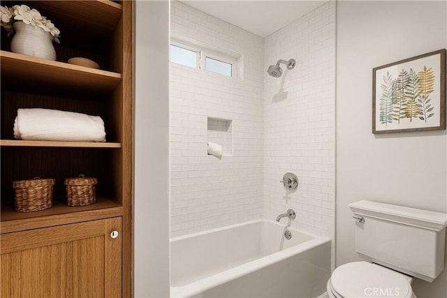 bathroom featuring tiled shower / bath combo and toilet