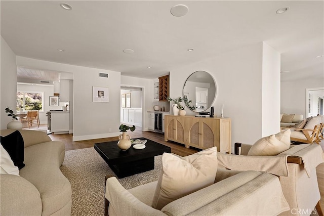 living area with visible vents, recessed lighting, dark wood-style floors, and beverage cooler