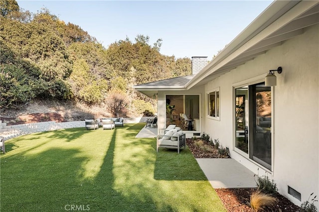 view of yard with an outdoor living space and a patio area