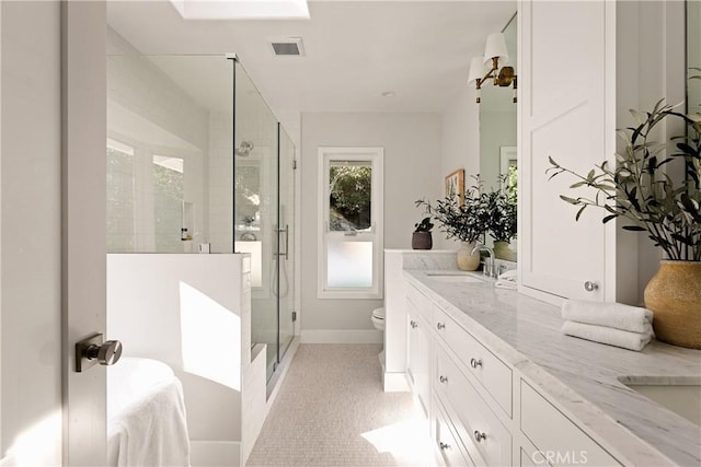 full bathroom featuring double vanity, visible vents, a stall shower, a sink, and toilet