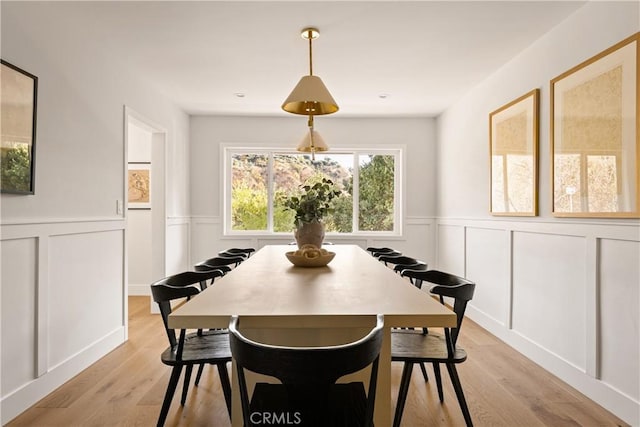 4031 Deerhorn Dr, Sherman Oaks, CA 91403 - dining room featuring a decorative wall, a wainscoted wall, and light wood-type flooring