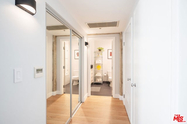 corridor with light hardwood / wood-style flooring