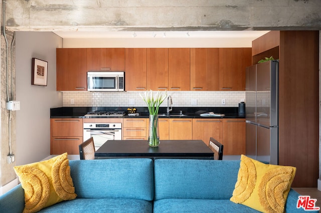 kitchen featuring sink, appliances with stainless steel finishes, and tasteful backsplash