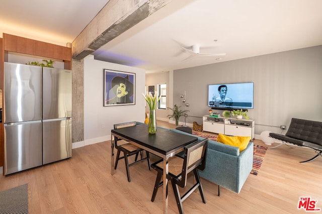 dining space with ceiling fan and light hardwood / wood-style flooring