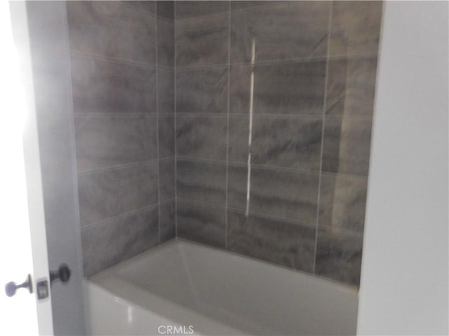 bathroom with shower / washtub combination