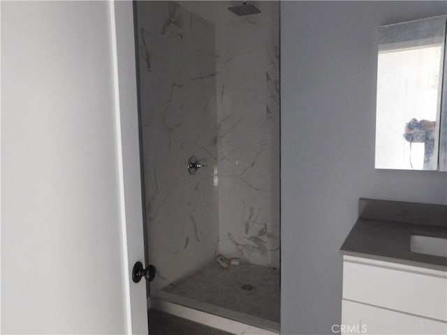 bathroom with walk in shower and vanity