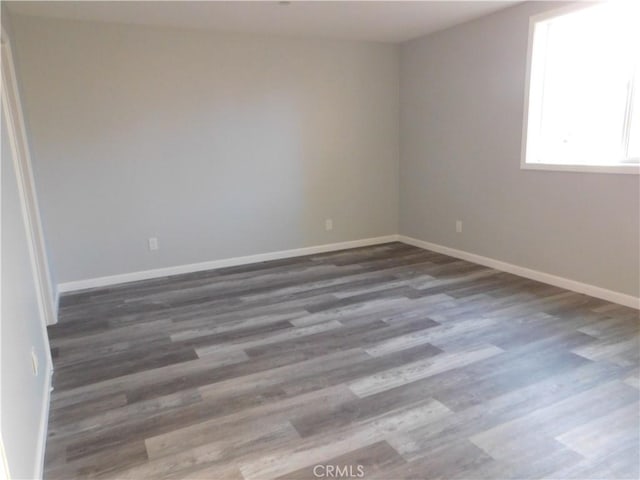 spare room with dark hardwood / wood-style floors