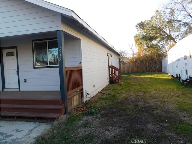 view of side of home featuring a lawn