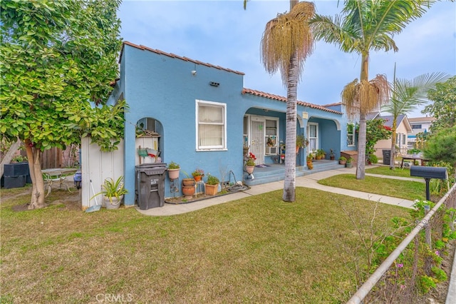 mediterranean / spanish-style house with a front yard