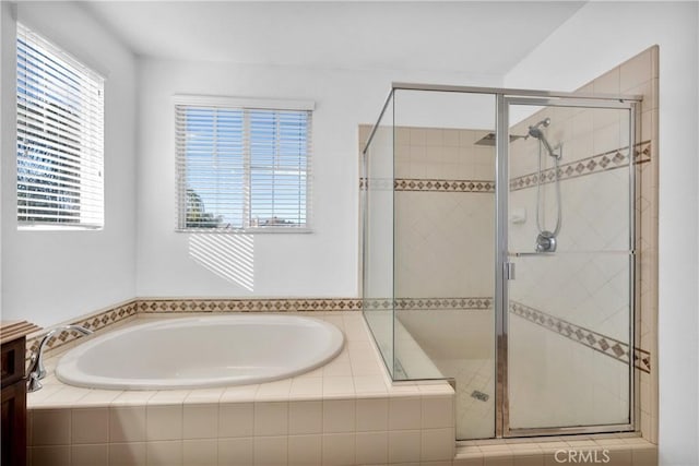 bathroom with separate shower and tub, plenty of natural light, and vanity