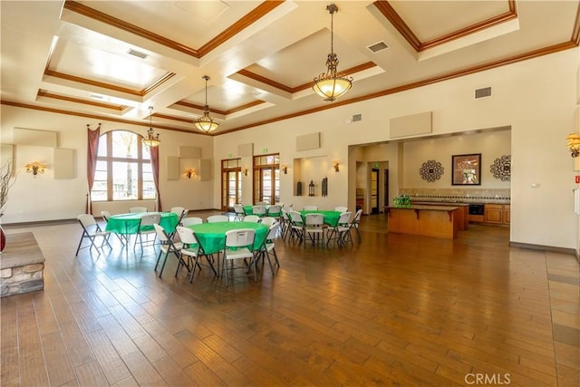 playroom featuring dark hardwood / wood-style floors, beamed ceiling, crown molding, and coffered ceiling