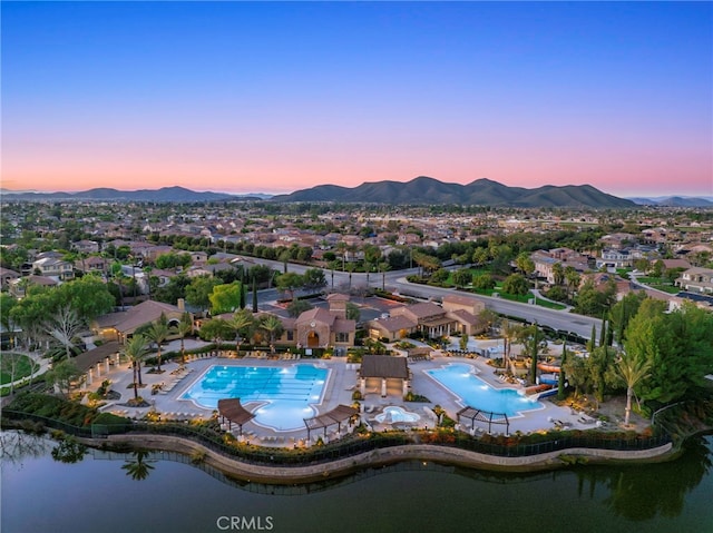 aerial view at dusk with a water and mountain view