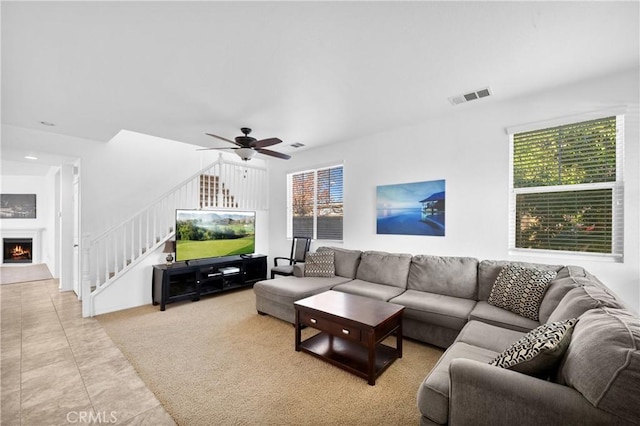 living room with ceiling fan and light tile patterned floors