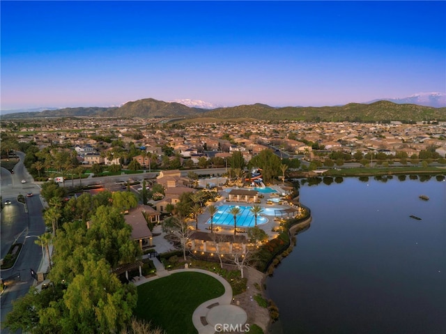 aerial view at dusk with a water and mountain view