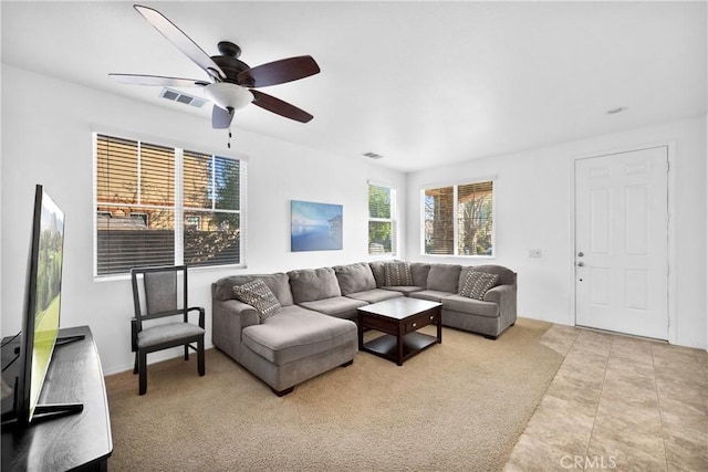 living room with ceiling fan and light carpet