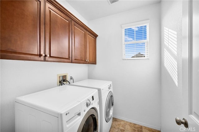 clothes washing area with independent washer and dryer and cabinets