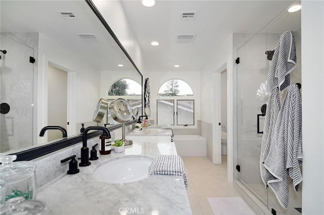 full bathroom with toilet, vanity, tile patterned floors, and independent shower and bath