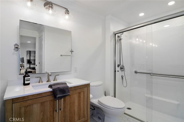 bathroom featuring toilet, vanity, a shower with door, and crown molding