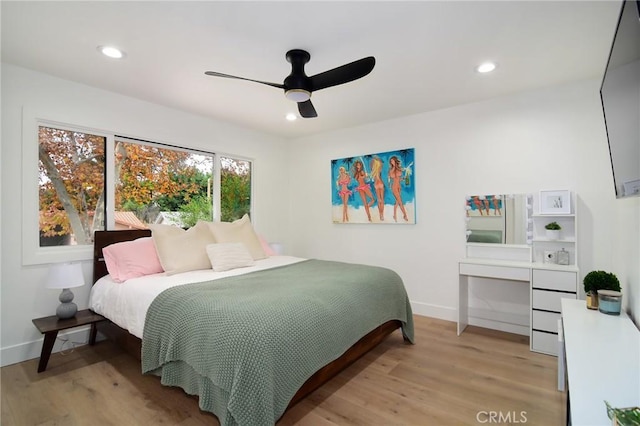 bedroom with ceiling fan and light hardwood / wood-style flooring