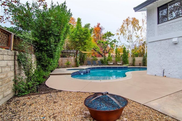 view of pool with an in ground hot tub and a patio