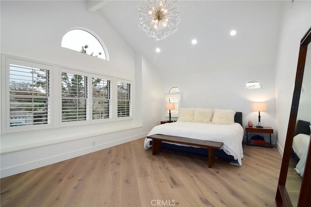 bedroom with high vaulted ceiling, light hardwood / wood-style flooring, beam ceiling, and a notable chandelier