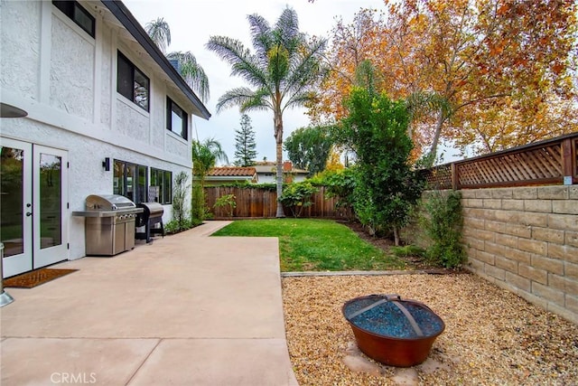 view of yard with french doors and a patio