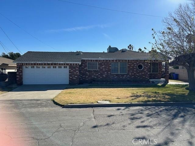 ranch-style home with a garage and a front lawn