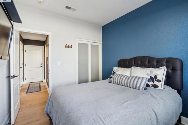 bedroom featuring light wood-type flooring and a closet