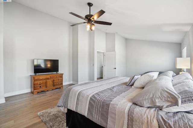 bedroom featuring ceiling fan, lofted ceiling, and light hardwood / wood-style floors