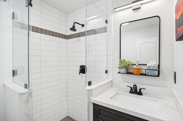 bathroom featuring walk in shower and vanity