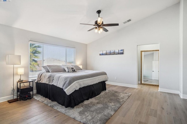 bedroom featuring ceiling fan, vaulted ceiling, and light wood-type flooring