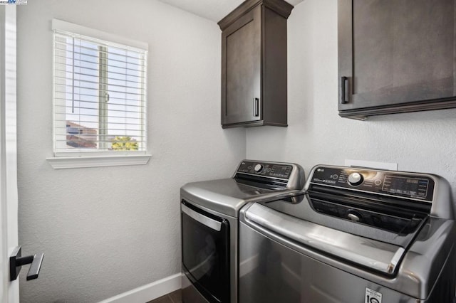 laundry room with cabinets and separate washer and dryer