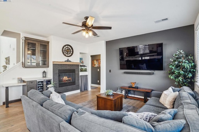 living room featuring ceiling fan and light hardwood / wood-style flooring