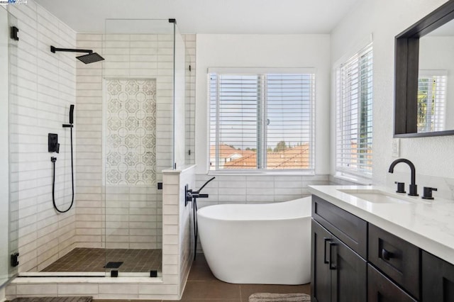 bathroom featuring shower with separate bathtub, tile walls, and tile patterned floors