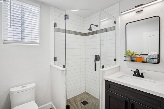 bathroom featuring toilet, an enclosed shower, and vanity