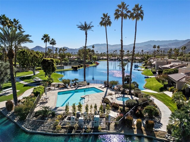 view of swimming pool featuring a patio area and a water and mountain view