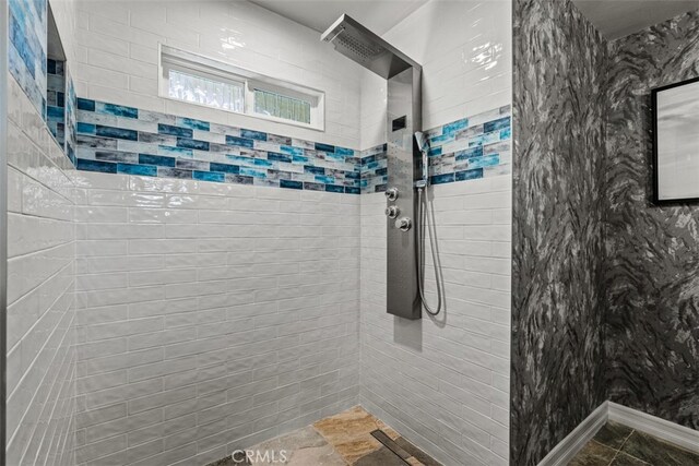 bathroom with a tile shower