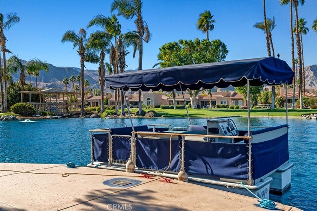 view of dock featuring a water and mountain view