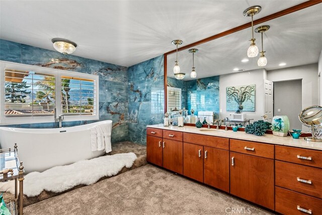 bathroom featuring vanity and independent shower and bath