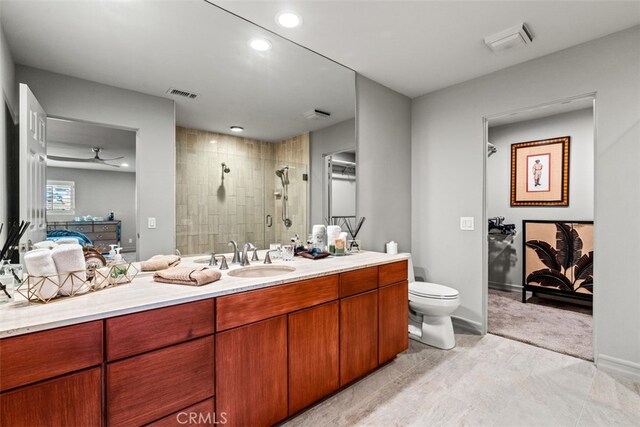 bathroom featuring ceiling fan, an enclosed shower, vanity, and toilet