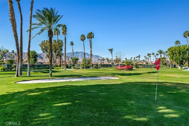 view of home's community featuring a lawn and a mountain view