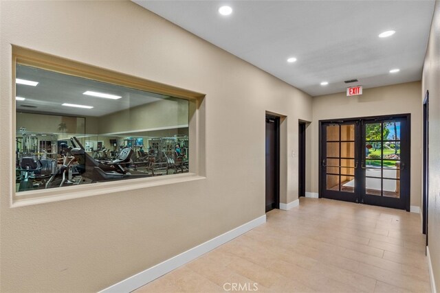 hall featuring light hardwood / wood-style floors and french doors