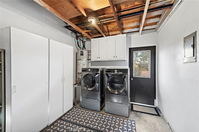 laundry area featuring cabinets, separate washer and dryer, electric panel, and gas water heater