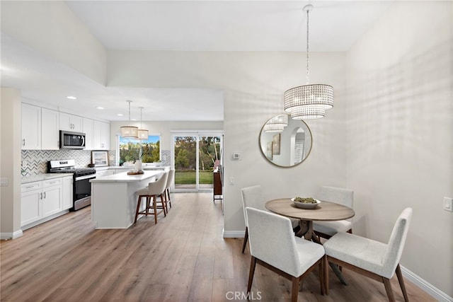 dining room with an inviting chandelier and light hardwood / wood-style floors